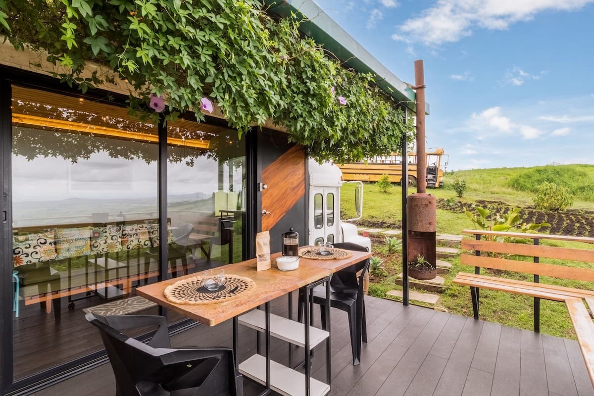Covered deck with dining table and valley view