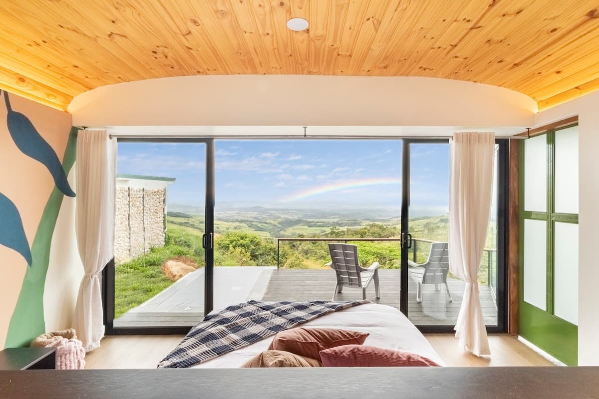 Queen bed facing glass doors and the terrace