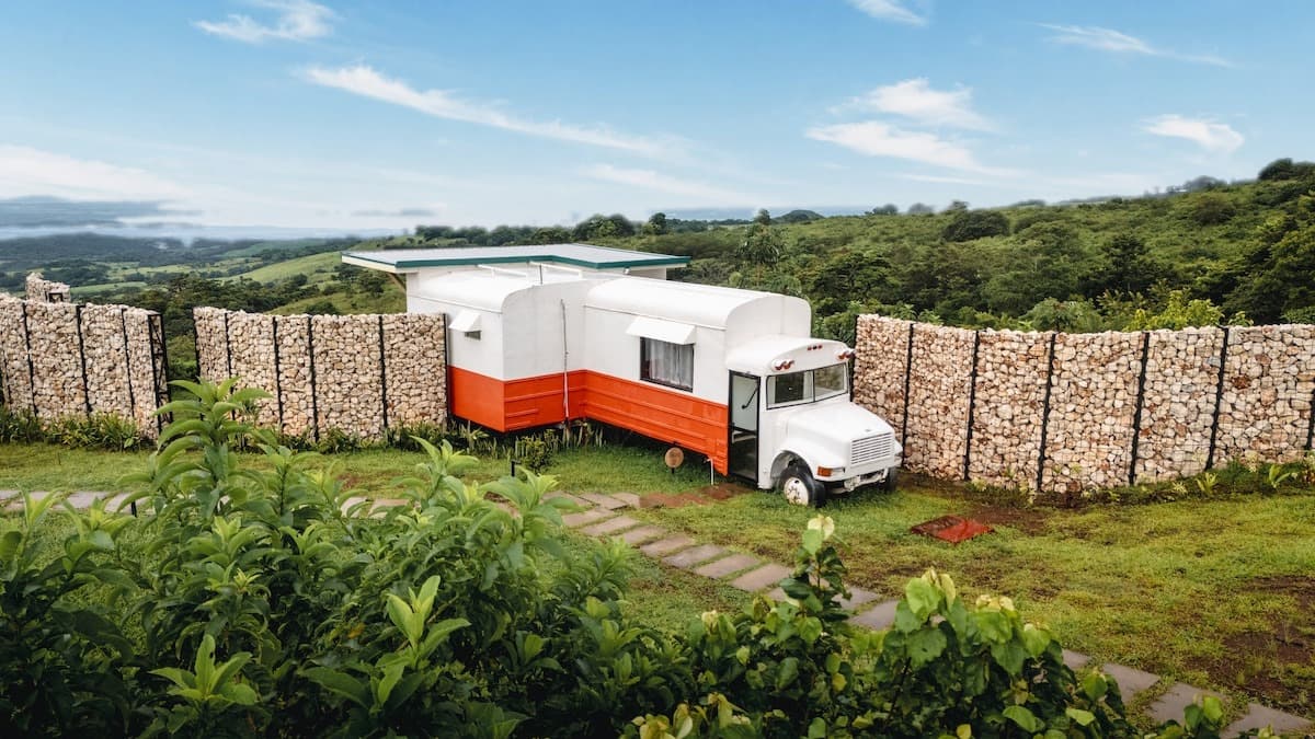 Bus 2, orange and white, between stone walls