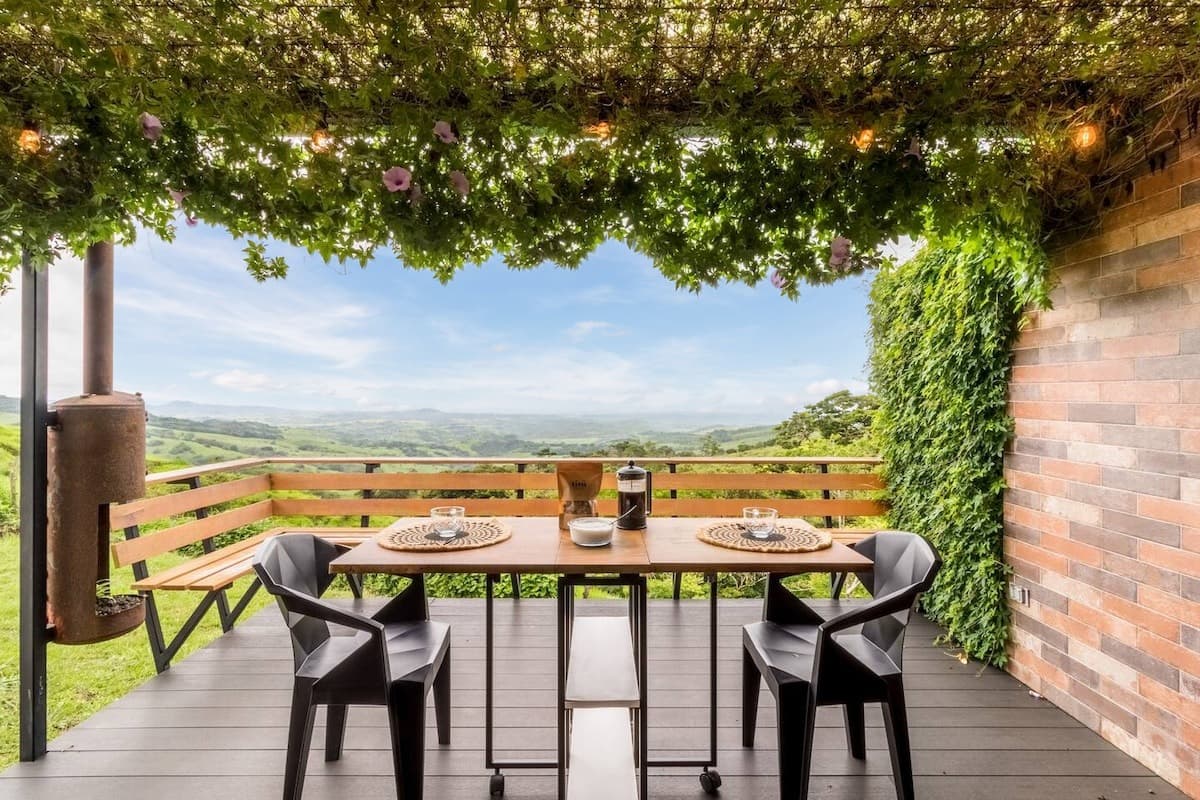 Deck dining under a vine-covered pergola