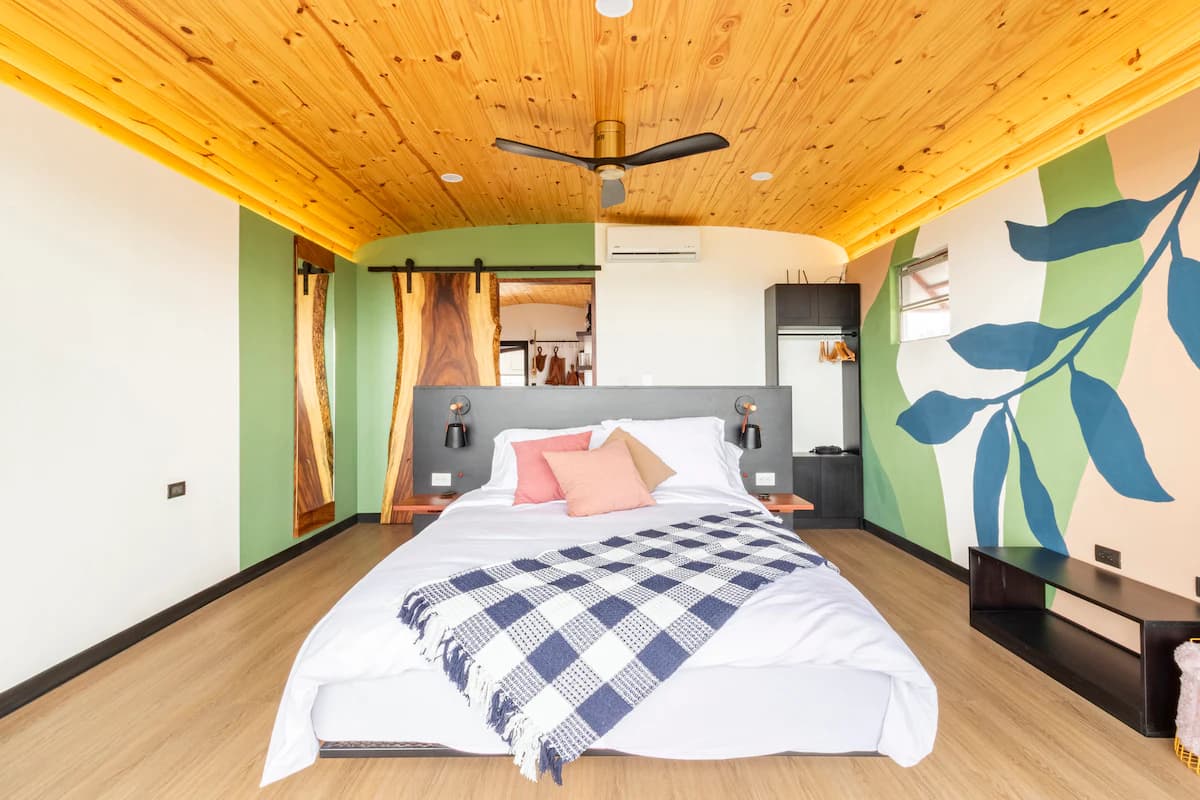 Bedroom with a painted leaf mural